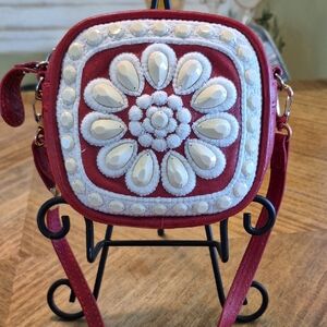 Brighton Mini Crossbody referred to as the Brighton Crown Jewel Winslet style. 